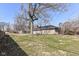 Spacious backyard featuring a large lawn and mature trees, perfect for outdoor activities at 7401 E 56Th St, Indianapolis, IN 46226