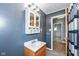Neutral-toned bathroom features a vanity sink with storage as well as linen storage and shower at 7401 E 56Th St, Indianapolis, IN 46226