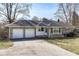 Charming single-story home featuring a two-car garage and a well-maintained front lawn at 7401 E 56Th St, Indianapolis, IN 46226