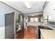 Cozy kitchen with stainless steel refrigerator and adjacent dining area with window views at 7401 E 56Th St, Indianapolis, IN 46226
