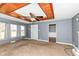 Spacious living room with natural light, wood-trimmed ceiling and neutral carpet at 7401 E 56Th St, Indianapolis, IN 46226