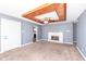 Cozy living room featuring a fireplace, ceiling fan, and wood-trimmed ceiling at 7401 E 56Th St, Indianapolis, IN 46226