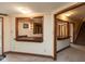 Finished basement with neutral carpet, a bar pass-through, and potential for versatile use with stairs and outside access at 8331 Lookout Ct, Indianapolis, IN 46217