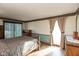 Bright bedroom features hardwood floors, a bed frame, and a sliding glass door allowing ample natural light at 8331 Lookout Ct, Indianapolis, IN 46217