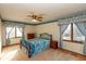 Bedroom featuring comfortable bed, a window with curtains, carpet, and a ceiling fan at 8331 Lookout Ct, Indianapolis, IN 46217