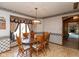 Dining room with wooden table and chairs, a large window, and wallpaper at 8331 Lookout Ct, Indianapolis, IN 46217
