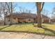 Charming single-story home with stone accents, mature trees, well-maintained lawn, and a welcoming front porch at 8331 Lookout Ct, Indianapolis, IN 46217