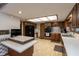 Well-lit kitchen with wood cabinets, laminate floors, a skylight, and black appliances at 8331 Lookout Ct, Indianapolis, IN 46217
