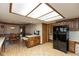 Eat-in kitchen with wooden cabinets, laminate floors, and a breakfast nook with backyard views at 8331 Lookout Ct, Indianapolis, IN 46217