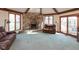 Cozy living room with stone fireplace, exposed beams, and sliding glass doors to the backyard at 8331 Lookout Ct, Indianapolis, IN 46217