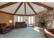 Spacious living room with stone fireplace, exposed beams, and ample natural light at 8331 Lookout Ct, Indianapolis, IN 46217
