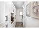 Well-organized laundry room with white cabinetry, storage, and a window for natural light at 10479 Dusty Rose Dr, Zionsville, IN 46077