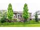 Well-manicured backyard with a covered patio and professional landscaping at 12167 Ams Run, Carmel, IN 46032