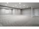 Spacious finished basement with neutral carpet, recessed lighting, and white support columns at 12167 Ams Run, Carmel, IN 46032