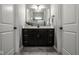 Bathroom vanity featuring a dark wood cabinet, white countertop, and large mirror at 12167 Ams Run, Carmel, IN 46032