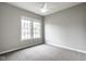 A bright bedroom with natural light from two windows and a ceiling fan at 12167 Ams Run, Carmel, IN 46032