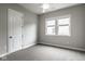 Bedroom with a large closet, two windows, neutral carpet, and base molding at 12167 Ams Run, Carmel, IN 46032