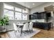 Bright dining room with modern chandelier, black cabinets, and large windows overlooking the neighborhood at 12167 Ams Run, Carmel, IN 46032