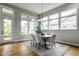 Bright dining room with modern lighting and large windows and a light-colored rug at 12167 Ams Run, Carmel, IN 46032