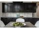 Close-up of dining area featuring dark cabinets and a stylish centerpiece on a wooden table at 12167 Ams Run, Carmel, IN 46032