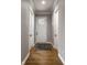 Bright hallway with hardwood floors and neutral walls, showcasing elegant doors and trim at 12167 Ams Run, Carmel, IN 46032