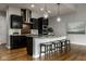 Well-equipped kitchen with dark cabinetry, stainless appliances, and stone countertops at 12167 Ams Run, Carmel, IN 46032