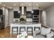Modern kitchen with dark cabinets, stainless appliances, and a large kitchen island at 12167 Ams Run, Carmel, IN 46032
