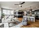Open-concept living area seamlessly blending the living room, dining space, and a modern kitchen with an island at 12167 Ams Run, Carmel, IN 46032
