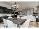 View of the open floor plan featuring kitchen, dining, and living areas with modern furnishings at 12167 Ams Run, Carmel, IN 46032