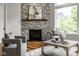 Cozy living room features a stone fireplace, comfortable seating, and natural light at 12167 Ams Run, Carmel, IN 46032