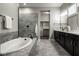 Luxurious main bathroom with soaking tub, tiled shower, and double vanity with dark cabinets at 12167 Ams Run, Carmel, IN 46032
