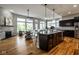 Spacious open floorplan with a kitchen island, stone fireplace, and hardwood floors at 12167 Ams Run, Carmel, IN 46032