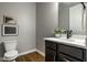 Chic powder room with modern fixtures, sleek vanity, and attractive decor at 12167 Ams Run, Carmel, IN 46032