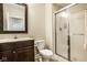 Bright bathroom featuring a glass-enclosed shower, a vanity with a framed mirror and toilet at 13018 Deerstyne Green St, Carmel, IN 46032