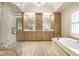 Main bathroom featuring double vanity, walk-in shower, soaking tub, and abundant storage at 13018 Deerstyne Green St, Carmel, IN 46032