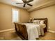 Cozy bedroom featuring a sleigh bed with decorative pillows and a ceiling fan at 13018 Deerstyne Green St, Carmel, IN 46032