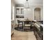 Bright dining area features stylish chandelier, built-in cabinet, and adjacent kitchen with modern fixtures at 13018 Deerstyne Green St, Carmel, IN 46032