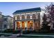 Inviting brick home featuring a covered front porch with seating, elegant architectural details, and manicured landscaping at 13018 Deerstyne Green St, Carmel, IN 46032