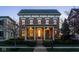 Traditional two-story brick home with a covered front porch and manicured landscaping at 13018 Deerstyne Green St, Carmel, IN 46032