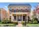 Charming brick home with a welcoming front porch, lush landscaping, and a well-manicured lawn at 13018 Deerstyne Green St, Carmel, IN 46032
