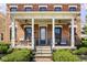 Welcoming front porch with comfortable seating, a brick facade, and elegant architectural details at 13018 Deerstyne Green St, Carmel, IN 46032