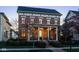 Charming brick two-story home with a covered front porch, classic design elements and manicured landscaping at 13018 Deerstyne Green St, Carmel, IN 46032