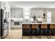 Modern kitchen with stainless steel appliances, white cabinets, and a large kitchen island at 13018 Deerstyne Green St, Carmel, IN 46032