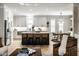 Gourmet kitchen featuring stainless steel appliances, white cabinets, and an island with bar seating at 13018 Deerstyne Green St, Carmel, IN 46032
