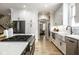 Well-equipped kitchen features a large island, stainless steel appliances, and stylish white cabinets at 13018 Deerstyne Green St, Carmel, IN 46032