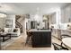 Open kitchen flows to the staircase and living room, featuring an island with barstool seating at 13018 Deerstyne Green St, Carmel, IN 46032