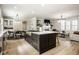 Open-concept kitchen showcases a large island, modern appliances, and seamless flow into the living space at 13018 Deerstyne Green St, Carmel, IN 46032