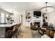 Open concept living room features a fireplace, built-in shelving, and a kitchen island with seating at 13018 Deerstyne Green St, Carmel, IN 46032