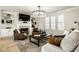 Bright living room featuring fireplace with built-in shelving, hardwood floors, and a decorative chandelier at 13018 Deerstyne Green St, Carmel, IN 46032
