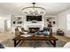 Well-lit living room features a fireplace, built-in shelving, hardwood floors, and stylish decor at 13018 Deerstyne Green St, Carmel, IN 46032
